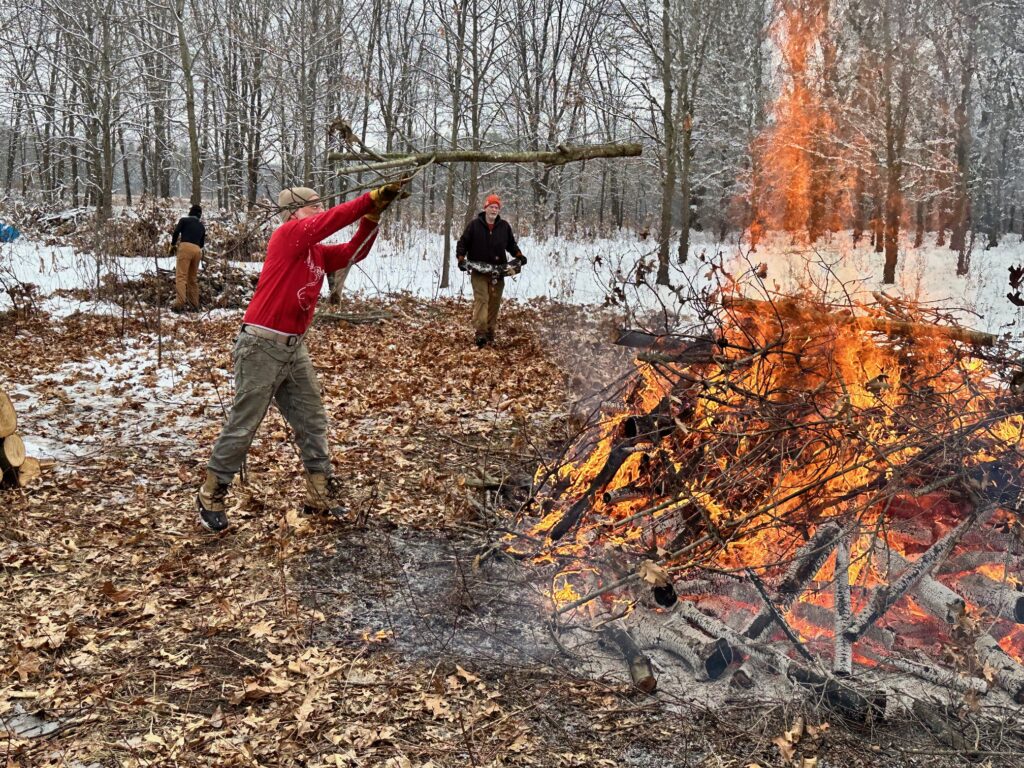 Photo 1. Kevin Mckown piling Oak branches on a burn pile on December 22, 2024.